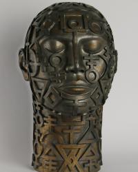 Ceramic head with elemental symbols and brown/bronze glaze