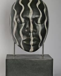 Raku fired  male African face, mounted on ceramic base