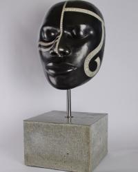 Raku fired ceramic male African face, mounted with steel rod on ceramic base