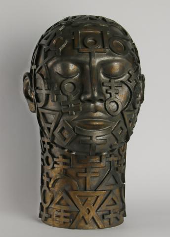 Ceramic head with elemental symbols and brown/bronze glaze