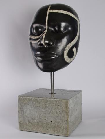 Raku fired ceramic male African face, mounted with steel rod on ceramic base